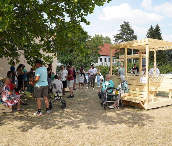 Verschiedene Menschen beim Feiern in der Siedlung